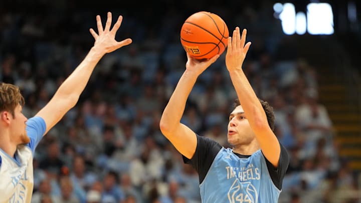 Oct 4, 2025; Charlotte, NC, USA; North Carolina Tar Heels guard Luka Bogavac (44) shoots as center Henri Veesaar (13) defends in the second half at Dean E. Smith Center. Mandatory Credit: Bob Donnan-Imagn Images Oct 4, 2025; Charlotte, NC, USA; North Carolina Tar Heels guard Luka Bogavac (44) shoots as center Henri Veesaar (13) defends in the second half at Dean E. Smith Center. Mandatory Credit: Bob Donnan-Imagn Images