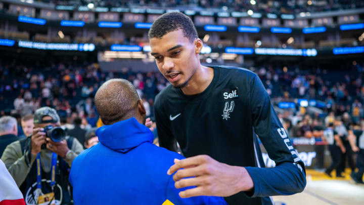 October 20, 2023; San Francisco, California, USA; Golden State Warriors guard Chris Paul (3, left) shakes hands with San Antonio Spurs center Victor Wembanyama (1, right) after the game at Chase Center. Mandatory Credit: Kyle Terada-USA TODAY Sports