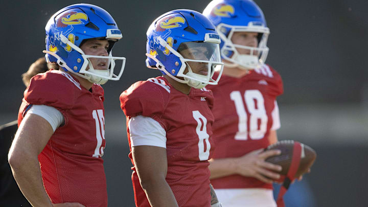 Kansas redshirt junior quarterback Cole Ballard (15) and Isaiah Marshall (8) watch during spring football practice Thursday, Mar. 26, 2026 in Lawrence, Kansas.