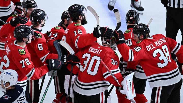 Oct 15, 2026; Chicago, Illinois, USA;  Chicago Blackhawks players celebrates with goalie Spencer Knight (30) after the overtime period against the Winnipeg Jets at the United Center.  Mandatory Credit: Matt Marton-Imagn Images
