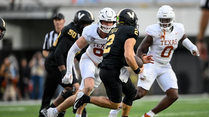 Texas Longhorns linebacker Ethan Burke (91) chases after Vanderbilt Commodores quarterback Diego Pavia (2) during the second half at FirstBank Stadium. Texas Longhorns linebacker Ethan Burke (91) chases after Vanderbilt Commodores quarterback Diego Pavia (2) during the second half at FirstBank Stadium.