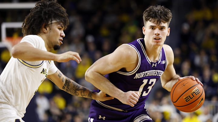 Jan 19, 2025; Ann Arbor, Michigan, USA;  Northwestern Wildcats guard Brooks Barnhizer (13) dribbles defended by Michigan Wolverines guard Tre Donaldson (3) in the second half at Crisler Center. Mandatory Credit: Rick Osentoski-Imagn Images
