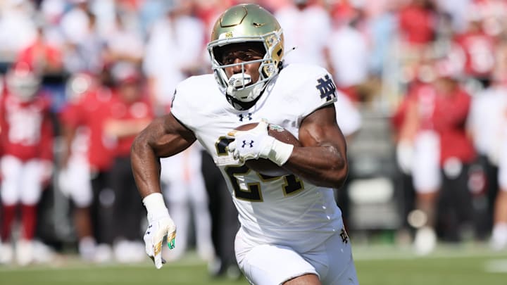 Sep 27, 2025; Fayetteville, Arkansas, USA; Notre Dame Fighting Irish running back Jadarian Price (24) rushes during the first quarter against the Arkansas Razorbacks at Donald W. Reynolds Razorback Stadium. 