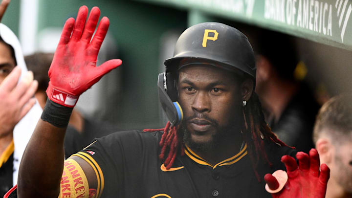 Aug 30, 2025; Boston, Massachusetts, USA; Pittsburgh Pirates center fielder Oneil Cruz (15) high-fives his teammates after hitting a solo home run against the Boston Red Sox during the fifth inning at Fenway Park. Mandatory Credit: Brian Fluharty-Imagn Images