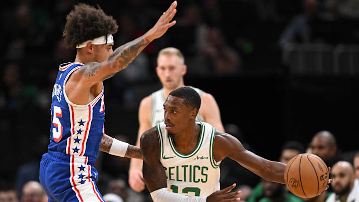 Oct 12, 2024; Boston, Massachusetts, USA; Boston Celtics guard Lonnie Walker IV (12) drives to the basket against Philadelphia 76ers guard Lester Quinones (25) during the first half at the TD Garden. Mandatory Credit: Brian Fluharty-Imagn Images