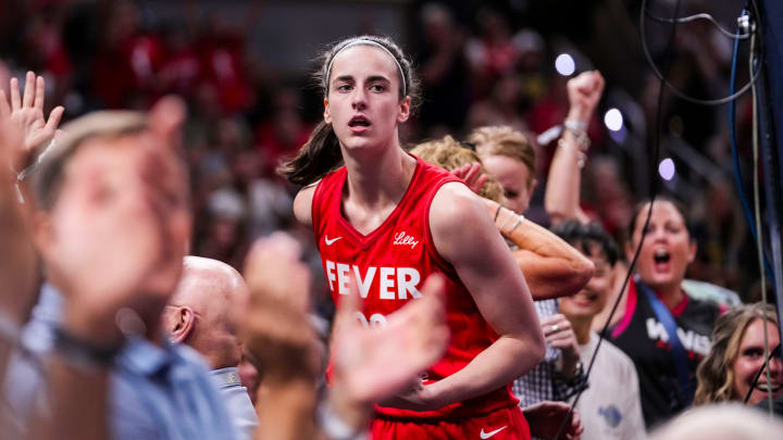 Indiana Fever guard Caitlin Clark (22) celebrates with fans behind the basket Friday, Aug. 16, 2024, during the game at Gainbridge Fieldhouse in Indianapolis. Indiana Fever guard Caitlin Clark (22) celebrates with fans behind the basket Friday, Aug. 16, 2024, during the game at Gainbridge Fieldhouse in Indianapolis.