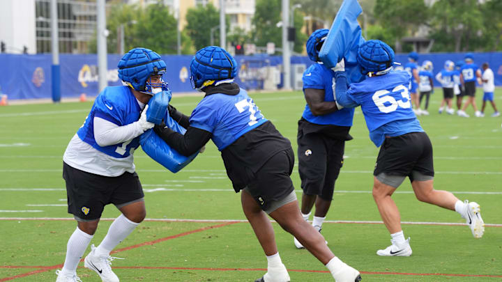 May 28, 2025; Woodland Hills, CA, USA; Los Angeles Rams offensive linemen (from left) Steve Avila (73),  Warren McClendon Jr.  (71), Kevin Dotson (69) and Dylan McMahon (63) participate in drills during organized team activities at Rams Practice Facility. Mandatory Credit: Kirby Lee-Imagn Images