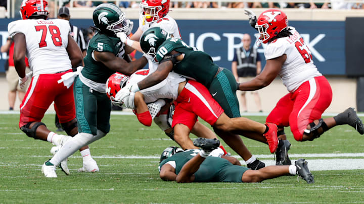 Michigan State linebackers Jordan Hall (5) and Wayne Matthews III (10) get involved in a tackle during a game against Youngstown State on Sept. 13, 2025.