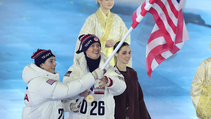 Team USA flagbearers Evan Bates and Hilary Knight walk during the closing ceremony.