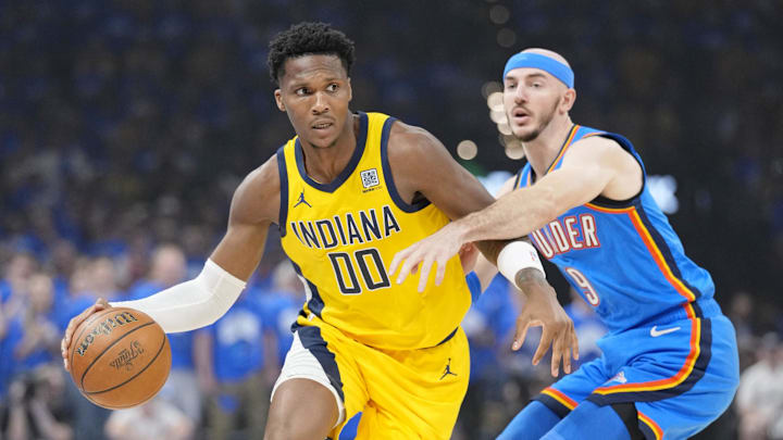 Jun 22, 2025; Oklahoma City, Oklahoma, USA; Indiana Pacers guard Bennedict Mathurin (00) dribbles the ball against Oklahoma City Thunder guard Alex Caruso (9) during the first half of game seven of the 2025 NBA Finals at Paycom Center. Mandatory Credit: Kyle Terada-Imagn Images