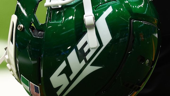 Oct 6, 2024; Tottenham, ENG; New York Jets helmets are held by staff before the match against Minnesota Vikings at Tottenham Hotspur Stadium. Mandatory Credit: Shaun Brooks-Imagn Images
