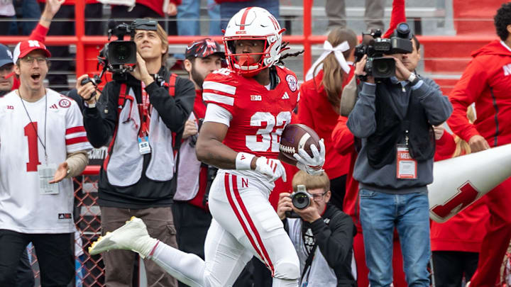 Nebraska's Kenneth Williams peeks back during his 95-yard kickoff return for a touchdown against Northwestern.