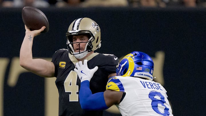 Dec 1, 2024; New Orleans, Louisiana, USA; New Orleans Saints quarterback Derek Carr (4) throws against Los Angeles Rams linebacker Jared Verse (8) during the first half at Caesars Superdome. Mandatory Credit: Matthew Hinton-Imagn Images Dec 1, 2024; New Orleans, Louisiana, USA; New Orleans Saints quarterback Derek Carr (4) throws against Los Angeles Rams linebacker Jared Verse (8) during the first half at Caesars Superdome. Mandatory Credit: Matthew Hinton-Imagn Images
