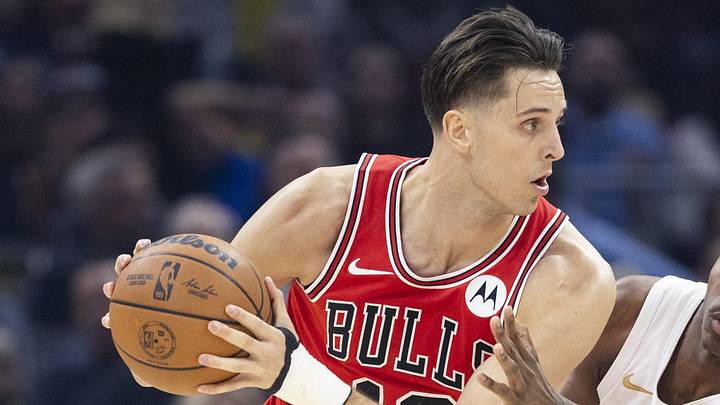 Dec 19, 2025; Cleveland, Ohio, USA; Chicago Bulls forward-center Zach Collins (12) keeps the ball away from Cleveland Cavaliers forward Nae'Qwan Tomlin (35) during the first quarter at Rocket Arena. Mandatory Credit: Scott Galvin-Imagn Images Dec 19, 2025; Cleveland, Ohio, USA; Chicago Bulls forward-center Zach Collins (12) keeps the ball away from Cleveland Cavaliers forward Nae'Qwan Tomlin (35) during the first quarter at Rocket Arena. Mandatory Credit: Scott Galvin-Imagn Images