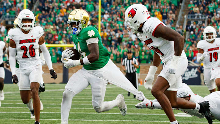 Notre Dame running back Jeremiyah Love (4) breaks free from a tackle on his way to score a touchdown during a NCAA college football game between Notre Dame and Louisville at Notre Dame Stadium on Saturday, Sept. 28, 2024, in South Bend. Notre Dame running back Jeremiyah Love (4) breaks free from a tackle on his way to score a touchdown during a NCAA college football game between Notre Dame and Louisville at Notre Dame Stadium on Saturday, Sept. 28, 2024, in South Bend.