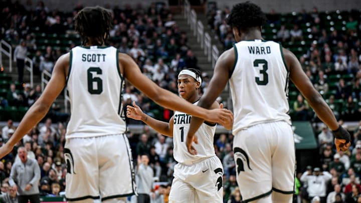 Michigan State's Jeremy Fears Jr., center, slaps hands with Jordan Scott, left, and Cam Ward, right, during the second half against Toledo on Tuesday, Dec. 16, 2025, at the Breslin Center in East Lansing.