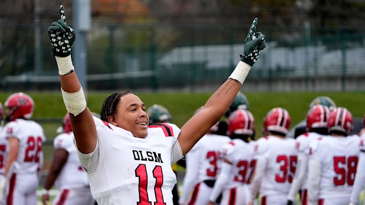 Orchard Lake St. Mary’s wide receiver Charles White celebrates looking over at students, friends and family in the stands after he and his teammates beat Birmingham Groves 28-27 in one overtime during the MHSAA Division 2 semifinal game at West Bloomfield High School in West Bloomfield on Saturday, Nov. 23, 2024.