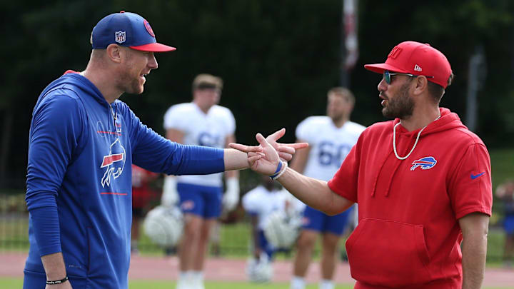 Bills offensive coordinator Joe Brady, left, and defensive coordinator Bobby Babich talk before the start of the final training camp session. Bills offensive coordinator Joe Brady, left, and defensive coordinator Bobby Babich talk before the start of the final training camp session.