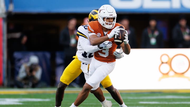 Michigan Wolverines defensive back Zeke Berry tackles Texas Longhorns wide receiver Emmett Mosley V during the first half at Camping World Stadium.