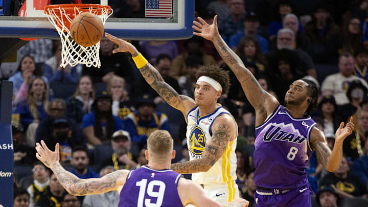 Apr 14, 2024; San Francisco, California, USA; Golden State Warriors guard Lester Quinones (25) passes away from defensive pressure by Utah Jazz forwards Luka Samanic (19) and Brice Sensabaugh (8) during the fourth quarter at Chase Center. Mandatory Credit: D. Ross Cameron-Imagn Images