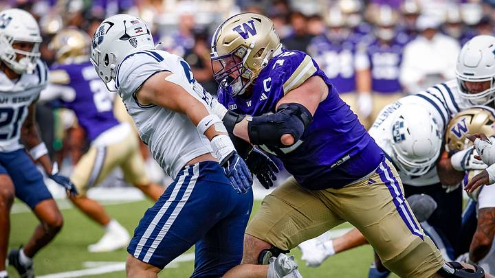 John Mills leans into a Utah State defender with an upfield block. John Mills leans into a Utah State defender with an upfield block.