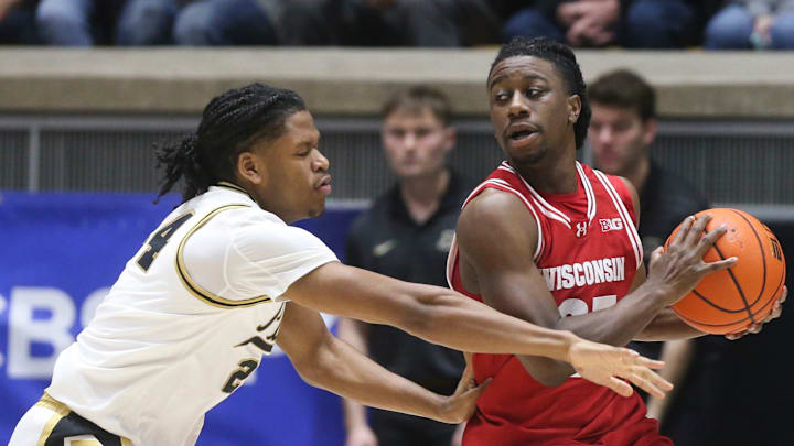 Purdue Boilermakers guard Gicarri Harris (24) defends Wisconsin Badgers guard John Blackwell (25) 