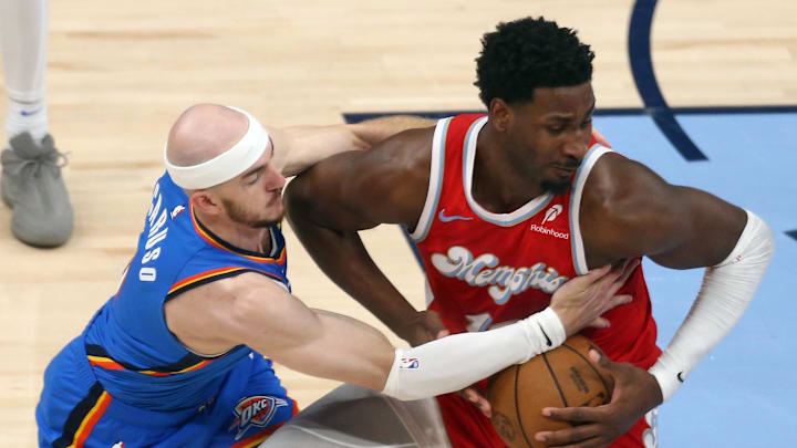 Apr 26, 2025; Memphis, Tennessee, USA; Memphis Grizzlies forward Jaren Jackson Jr. (13) spins to the basket as Oklahoma City Thunder guard Alex Caruso (9) defends during the first quarter in Game 4 of the first round at FedExForum. Mandatory Credit: Petre Thomas-Imagn Images