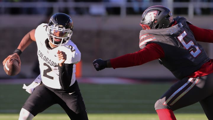 Colorado's Shedeur Sanders escapes pressure from Texas Tech in a Big 12 football game Saturday, Nov. 9, 2024, at Jones AT&T Stadium.