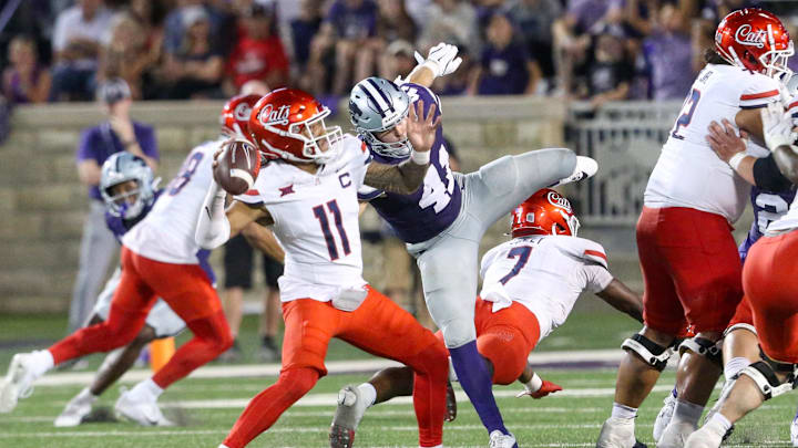 Sep 13, 2024; Manhattan, Kansas, USA; Arizona Wildcats quarterback Noah Fifita (11) passes the ball while being rushed by Kansas State Wildcats linebacker Austin Moore (41) at Bill Snyder Family Football Stadium.