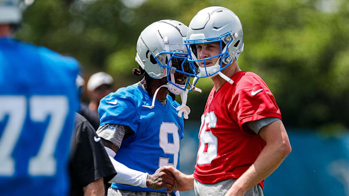 Detroit Lions wide receiver Jameson Williams (9) shakes hands with quarterback Jared Goff (16) at practice during mini camp at Detroit Lions headquarters and practice facility in Allen Park on Tuesday, June 4, 2024.