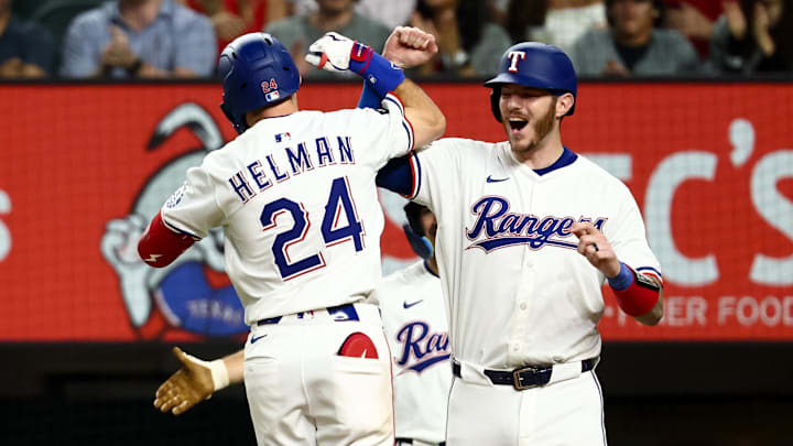 Texas Rangers center fielder Michael Helman (24) celebrates with Texas Rangers catcher Jonah Heim (28) after hitting a two-run home run during the fifth inning against the Milwaukee Brewers at Globe Life Field.