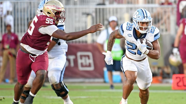 Nov 2, 2024; Tallahassee, Florida, USA;  North Carolina Tarheels running back Omarian Hampton (28) runs a shovel pass for a touchdown against the Florida State Seminoles during the fourth quarter at Doak S. Campbell Stadium. Mandatory Credit: Robert Myers-Imagn Images