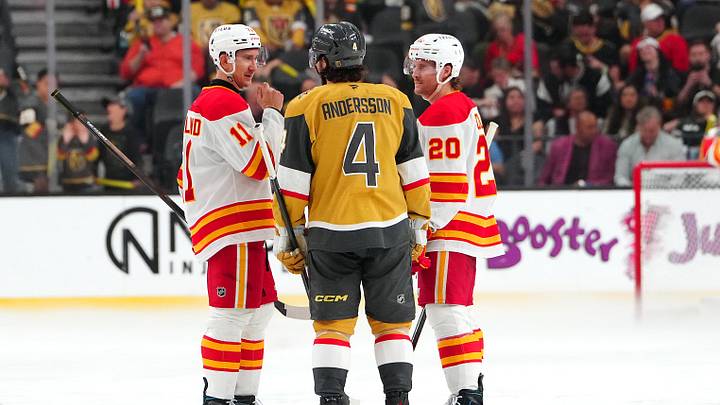 Apr 2, 2026; Las Vegas, Nevada, USA; Vegas Golden Knights defenseman Rasmus Andersson (4) talks with Calgary Flames center Mikael Backlund (11) an left wing Blake Coleman (20) as repairs are made to the ice before the start of the third period at T-Mobile Arena. Mandatory Credit: Stephen R. Sylvanie-Imagn Images Apr 2, 2026; Las Vegas, Nevada, USA; Vegas Golden Knights defenseman Rasmus Andersson (4) talks with Calgary Flames center Mikael Backlund (11) an left wing Blake Coleman (20) as repairs are made to the ice before the start of the third period at T-Mobile Arena. Mandatory Credit: Stephen R. Sylvanie-Imagn Images