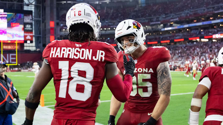 Jan 5, 2025; Glendale, Arizona, USA; Arizona Cardinals wide receiver Marvin Harrison Jr. (18) celebrates a touchdown with tight end Trey McBride (85) against the San Francisco 49ers in the second half at State Farm Stadium. Mandatory Credit: Mark J. Rebilas-Imagn Images