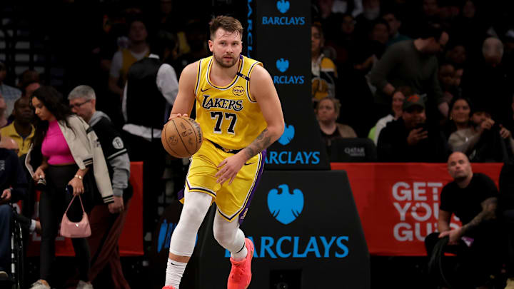 Los Angeles Lakers guard Luka Doncic (77) brings the ball up court against the Brooklyn Nets during the first quarter at Barclays Center. 