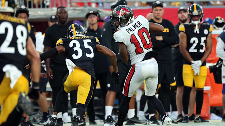 Aug 11, 2023; Tampa, Florida, USA; Tampa Bay Buccaneers wide receiver Trey Palmer (10) catches the ball as Pittsburgh Steelers cornerback Luq Barcoo (35) defends during the first half at Raymond James Stadium. Mandatory Credit: Kim Klement Neitzel-Imagn Images