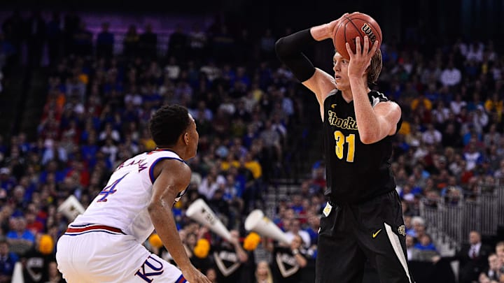 Mar 22, 2015; Omaha, NE, USA; Kansas Jayhawks guard Devonte Graham (4) guards Wichita State Shockers guard Ron Baker
