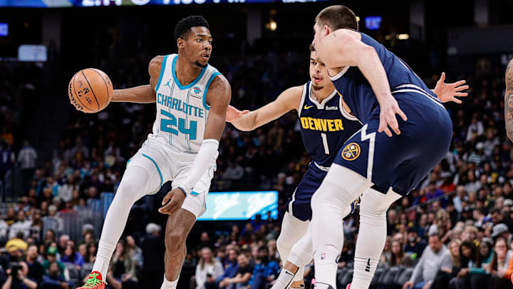 Jan 1, 2024; Denver, Colorado, USA; Charlotte Hornets forward Brandon Miller (24) controls the ball