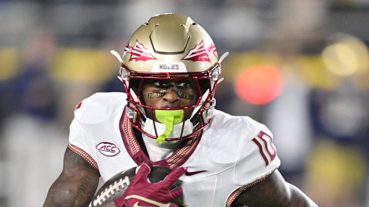 Nov 9, 2024; South Bend, Indiana, USA; Florida State Seminoles wide receiver Malik Benson (10) carries against the Notre Dame Fighting Irish in the first quarter at Notre Dame Stadium. Mandatory Credit: Matt Cashore-Imagn Images