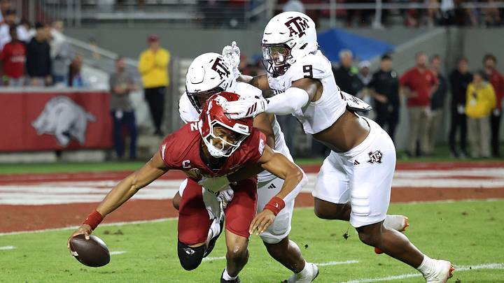 Texas A&M Aggies defensive end Dayon Hayes (50) sacks Arkansas Razorbacks quarterback Taylen Green (10) during the fourth quarter as Aggies defensive end Cashius Howell (9) closes in at Donald W. Reynolds Razorback Stadium. Texas A&M Aggies defensive end Dayon Hayes (50) sacks Arkansas Razorbacks quarterback Taylen Green (10) during the fourth quarter as Aggies defensive end Cashius Howell (9) closes in at Donald W. Reynolds Razorback Stadium.