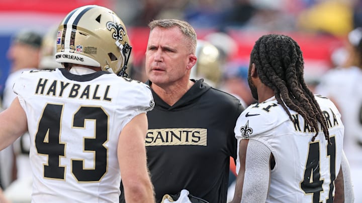Dec 8, 2024; East Rutherford, New Jersey, USA; New Orleans Saints head coach Darren Rizzi talks with punter Matthew Hayball (43) and running back Alvin Kamara (41) during the first half against the New York Giants at MetLife Stadium. Mandatory Credit: Vincent Carchietta-Imagn Images