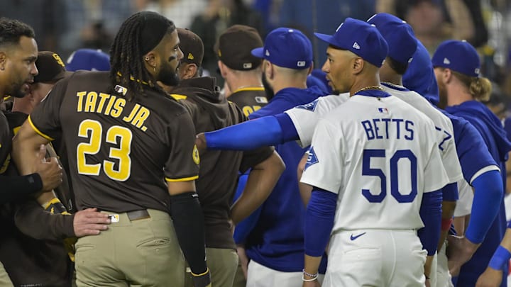 Jun 19, 2025; Los Angeles, California, USA;   San Diego Padres right fielder Fernando Tatis Jr. (23) and Los Angeles Dodgers shortstop Mookie Betts (50) engage on the field after benches cleared in the eighth inning at Dodger Stadium. Mandatory Credit: Jayne Kamin-Oncea-Imagn Images