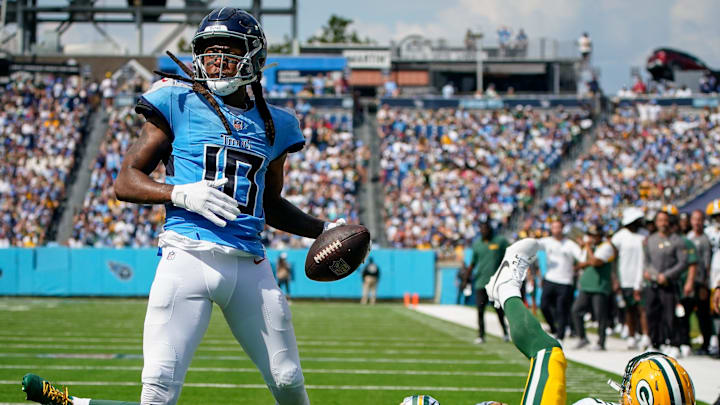 Tennessee Titans wide receiver DeAndre Hopkins (10) scores a touchdown past Green Bay Packers cornerback Eric Stokes (21) and safety Xavier McKinney (29) during the third quarter at Nissan Stadium in Nashville, Tenn., Sunday, Sept. 22, 2024.