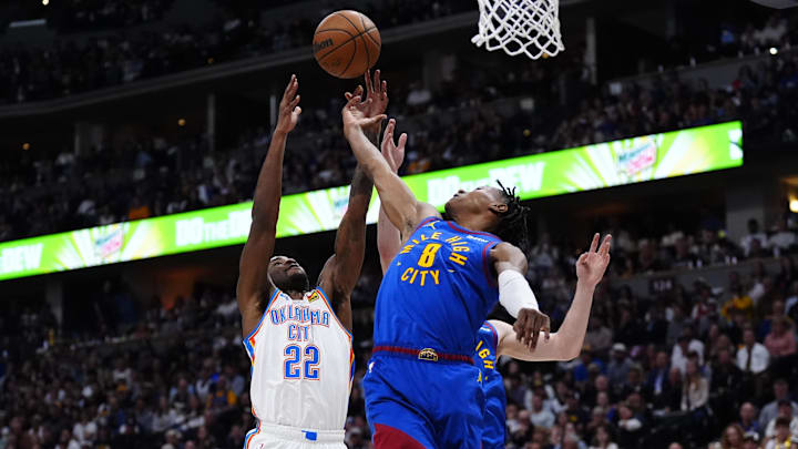 May 9, 2025; Denver, Colorado, USA; Oklahoma City Thunder guard Cason Wallace (22) and Denver Nuggets forward Peyton Watson (8) reach for the ball in the first half during Game 3 of the second round at Ball Arena. Mandatory Credit: Ron Chenoy-Imagn Images May 9, 2025; Denver, Colorado, USA; Oklahoma City Thunder guard Cason Wallace (22) and Denver Nuggets forward Peyton Watson (8) reach for the ball in the first half during Game 3 of the second round at Ball Arena. Mandatory Credit: Ron Chenoy-Imagn Images