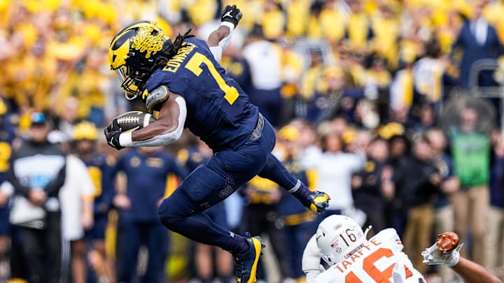 Michigan running back Donovan Edwards (7) runs for a first down against Texas defensive back Michael Taaffe (16) during the first half at Michigan Stadium in Ann Arbor on Saturday, September 7, 2024. Michigan running back Donovan Edwards (7) runs for a first down against Texas defensive back Michael Taaffe (16) during the first half at Michigan Stadium in Ann Arbor on Saturday, September 7, 2024.