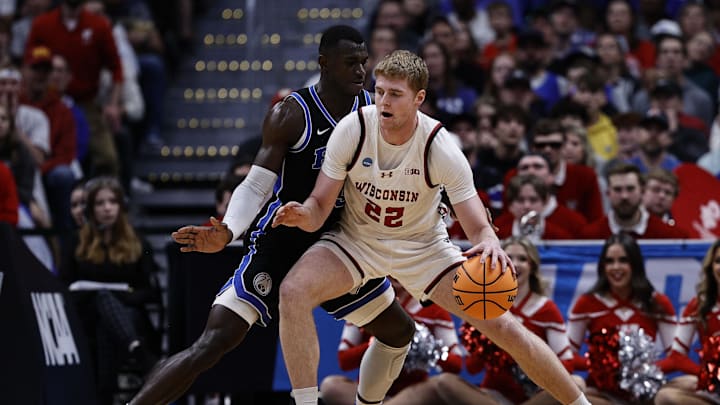 Mar 22, 2025; Denver, CO, USA; Wisconsin Badgers forward Steven Crowl (22) dribbles the ball against Brigham Young Cougars center Keba Keita (13) during the second half in the second round of the NCAA Tournament at Ball Arena. Mandatory Credit: Isaiah J. Downing-Imagn Images Mar 22, 2025; Denver, CO, USA; Wisconsin Badgers forward Steven Crowl (22) dribbles the ball against Brigham Young Cougars center Keba Keita (13) during the second half in the second round of the NCAA Tournament at Ball Arena. Mandatory Credit: Isaiah J. Downing-Imagn Images