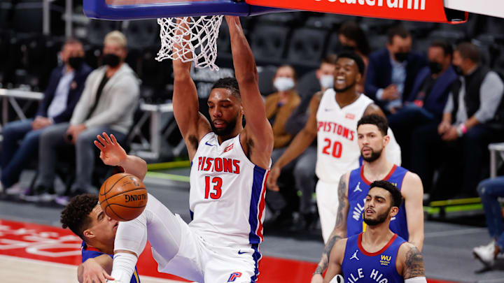 May 14, 2021; Detroit, Michigan, USA; Detroit Pistons center Jahlil Okafor (13) dunks on Denver Nuggets forward Michael Porter Jr. (1) in the first half at Little Caesars Arena. Mandatory Credit: Rick Osentoski-Imagn Images