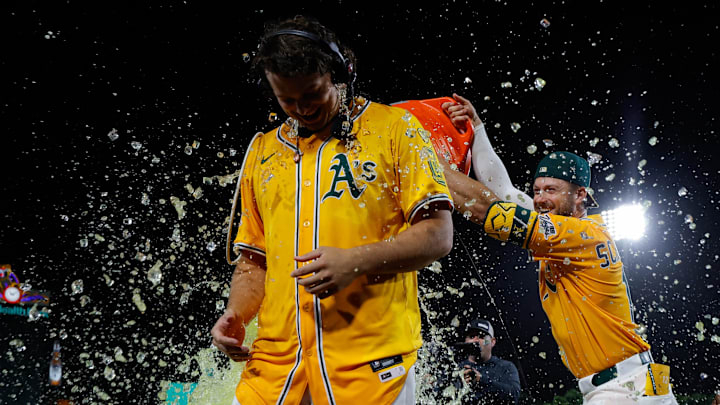Jun 19, 2025; West Sacramento, California, USA; Athletics first baseman Nick Kurtz (16) gets a gatorade splash by third base Max Schuemann (12) and right fielder Lawrence Butler (4) after hitting a walk-off two run home run during the tenth inning against the Houston Astros at Sutter Health Park. Mandatory Credit: Sergio Estrada-Imagn Images Jun 19, 2025; West Sacramento, California, USA; Athletics first baseman Nick Kurtz (16) gets a gatorade splash by third base Max Schuemann (12) and right fielder Lawrence Butler (4) after hitting a walk-off two run home run during the tenth inning against the Houston Astros at Sutter Health Park. Mandatory Credit: Sergio Estrada-Imagn Images