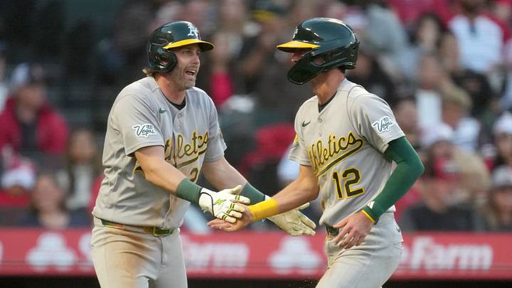 Jun 26, 2026; Anaheim, California, USA;  Athletics shortstop Alika Williams (12) is congratulated by second baseman Jeff McNeil (22) after scoring in the fifth inning against the Los Angeles Angels at Angel Stadium. Mandatory Credit: Kirby Lee-Imagn Images