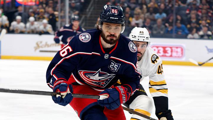 Apr 12, 2026; Columbus, Ohio, USA; Columbus Blue Jackets right wing Kirill Marchenko (86) and Boston Bruins defenseman Jonathan Aspirot (45) skate after a loose puck during the first period at Nationwide Arena. Mandatory Credit: Russell LaBounty-Imagn Images